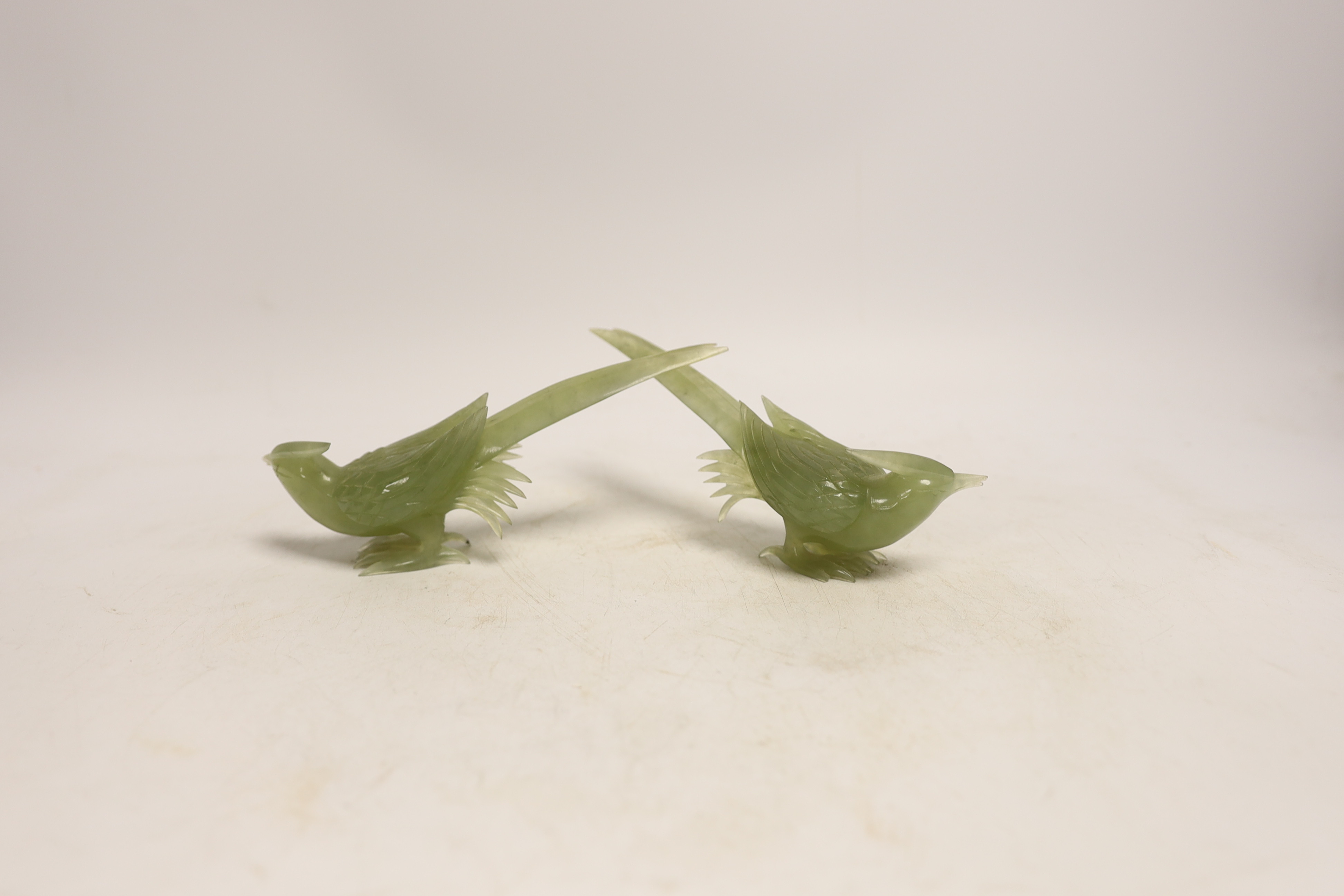 A pair of carved bowenite jade birds on stands, boxed